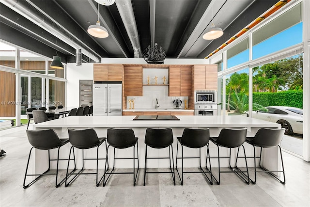 kitchen featuring a breakfast bar, stainless steel appliances, and a large island