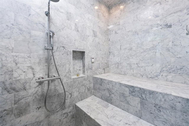 bathroom with a tile shower