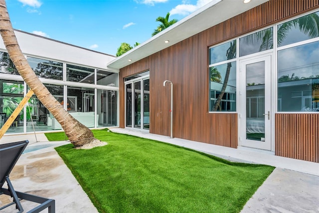 rear view of property featuring a lawn