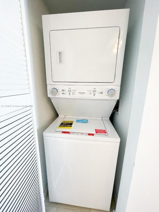 laundry room with stacked washing maching and dryer