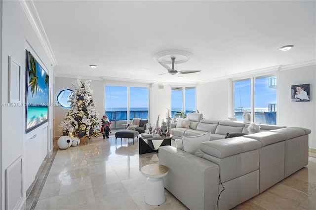 living room with a wall of windows, ceiling fan, a water view, and ornamental molding