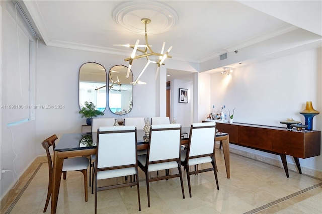 dining room with crown molding and a notable chandelier