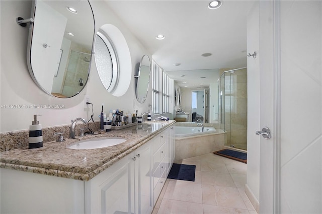 bathroom featuring tile patterned flooring, vanity, and independent shower and bath