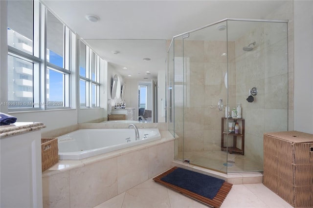 bathroom featuring tile patterned flooring, vanity, plenty of natural light, and independent shower and bath