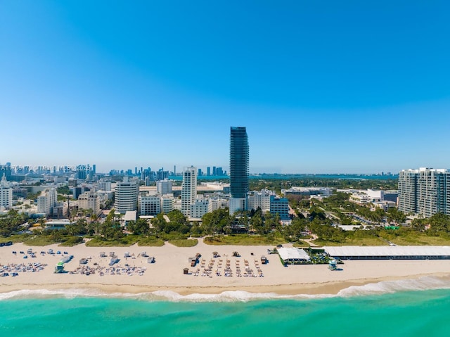 aerial view with a water view, a view of the beach, and a city view