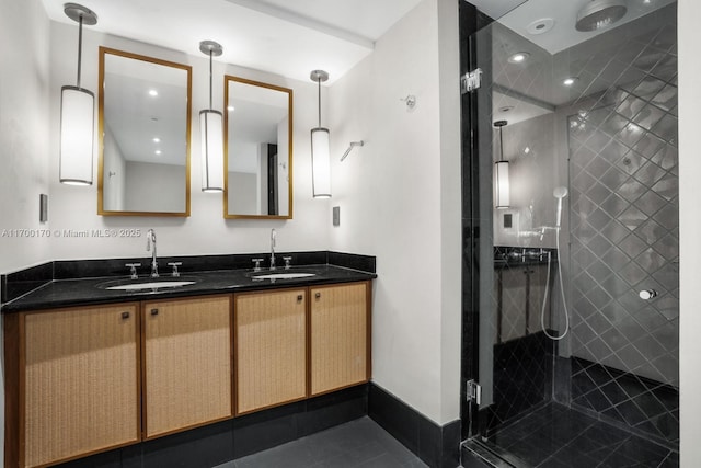 full bath featuring double vanity, a sink, and a shower stall