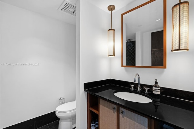 bathroom with tile patterned flooring, visible vents, vanity, and toilet