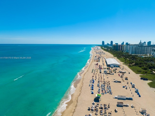 bird's eye view featuring a water view, a view of city, and a view of the beach