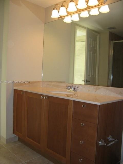 bathroom featuring tile patterned flooring and vanity