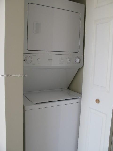 laundry area with stacked washing maching and dryer