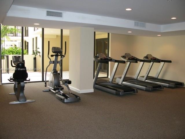 workout area featuring a tray ceiling