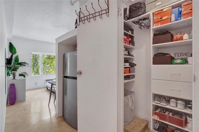 bedroom featuring a wall mounted air conditioner and light tile patterned flooring