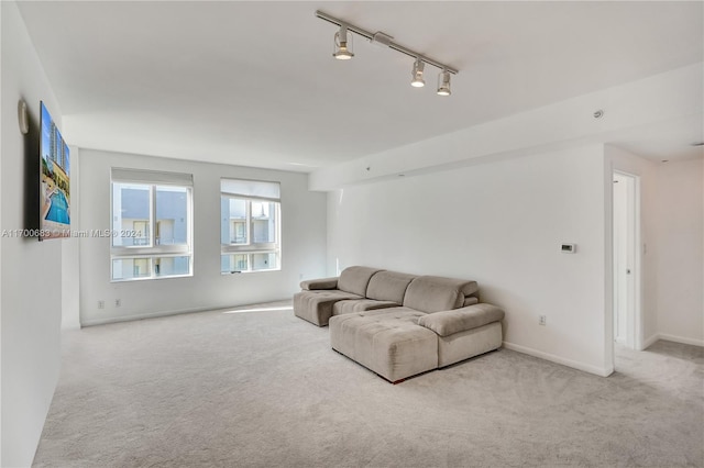 carpeted living room featuring track lighting