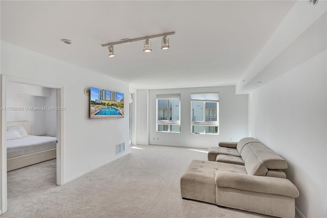 living room featuring light colored carpet and track lighting