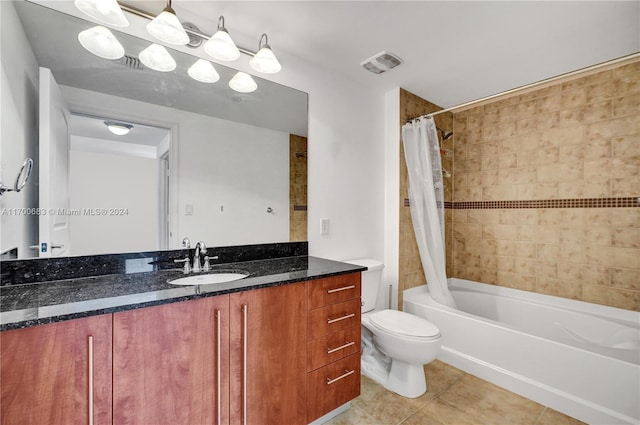 full bathroom with shower / bath combo, vanity, tile patterned flooring, and toilet