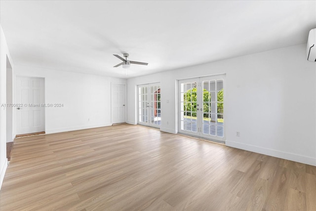 spare room with ceiling fan, light wood-type flooring, and french doors