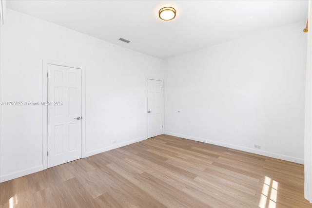 spare room featuring light hardwood / wood-style floors