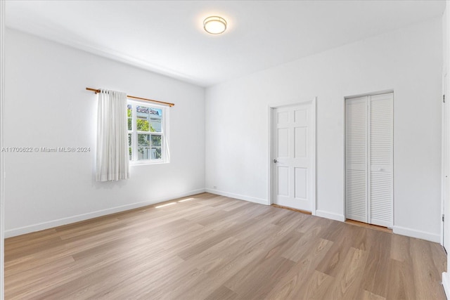 unfurnished bedroom with light wood-type flooring