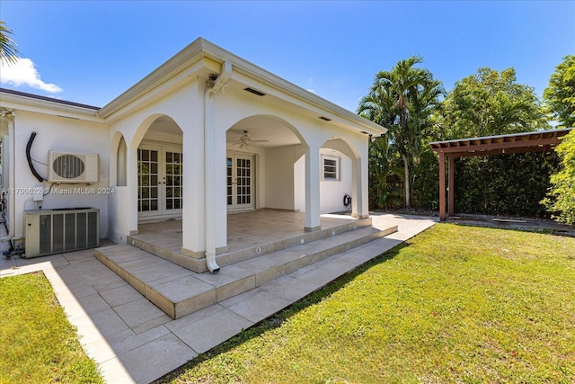 exterior space with ceiling fan, a yard, french doors, ac unit, and a patio area