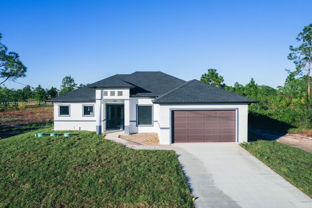 view of front of home featuring a front lawn and a garage