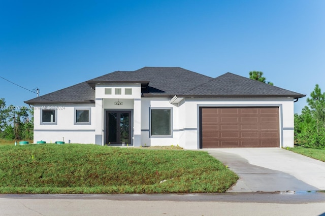 prairie-style house with a garage and a front yard