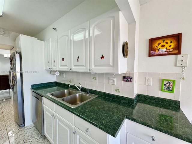 kitchen featuring white cabinetry, sink, appliances with stainless steel finishes, and tasteful backsplash