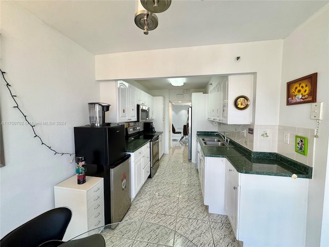 kitchen featuring white cabinets, sink, stainless steel appliances, and tasteful backsplash