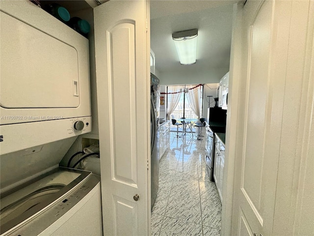 laundry area featuring stacked washer and clothes dryer