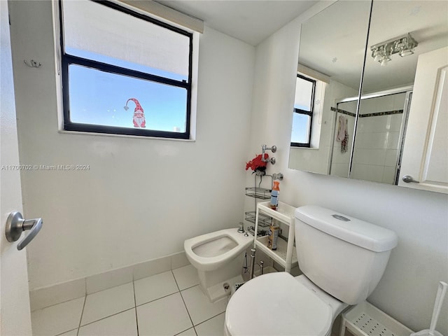 bathroom with a shower with curtain, plenty of natural light, a bidet, and tile patterned flooring