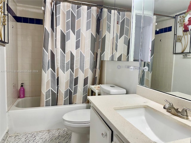 full bathroom featuring vanity, shower / bath combination with curtain, and toilet