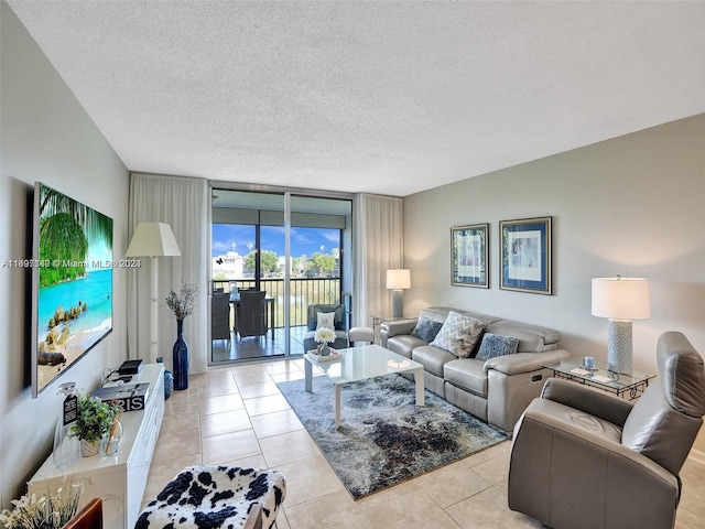 tiled living room with a wall of windows and a textured ceiling