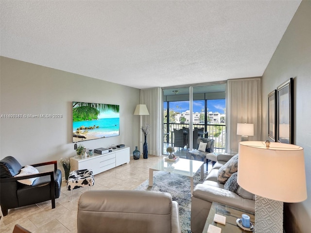 living room with a textured ceiling and a wall of windows