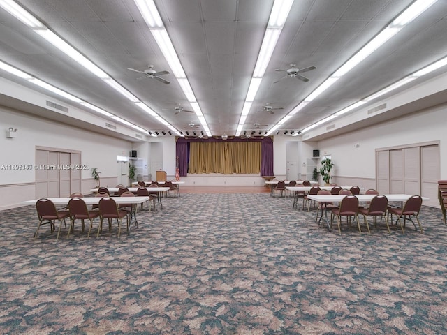 carpeted dining area with ceiling fan