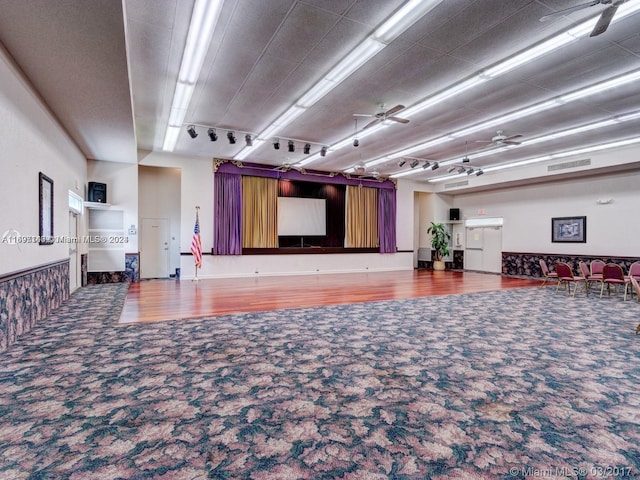 interior space with ceiling fan