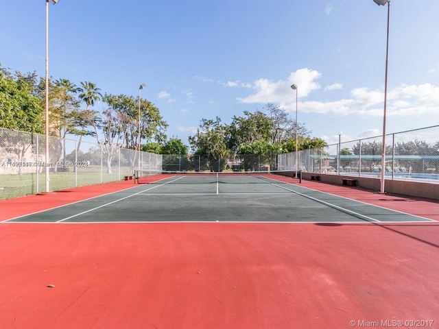 view of tennis court featuring basketball court