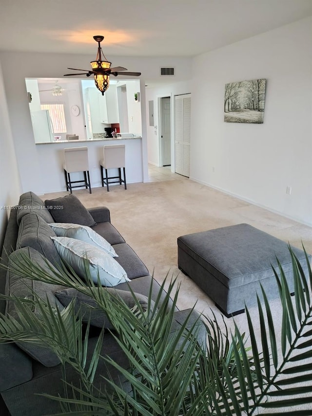 carpeted living room featuring ceiling fan