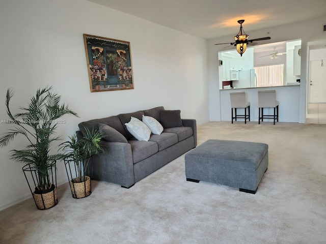 living room with ceiling fan and light colored carpet