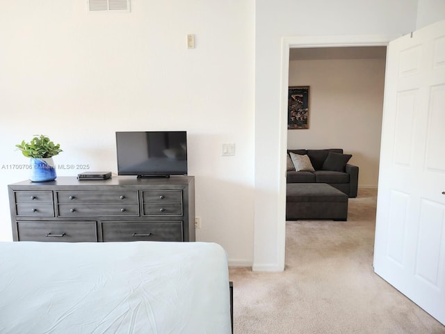 bedroom featuring light carpet