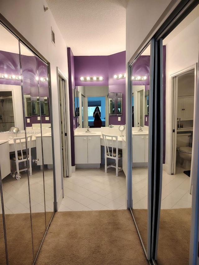 bathroom with tile patterned flooring, toilet, and sink