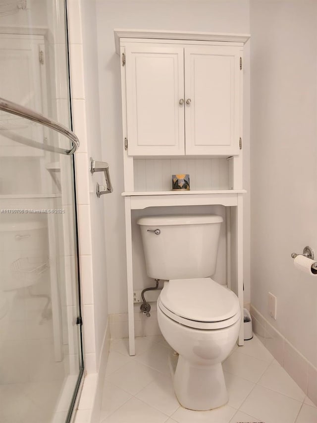 bathroom with tile patterned flooring, toilet, and walk in shower