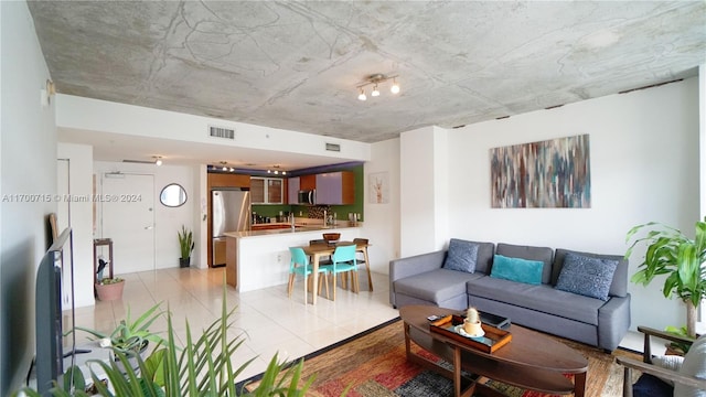 living room featuring light tile patterned floors and sink