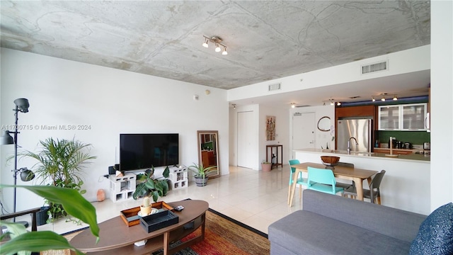 tiled living room featuring sink