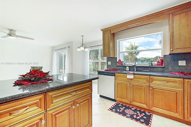 kitchen featuring decorative backsplash, sink, stainless steel dishwasher, and light tile patterned flooring