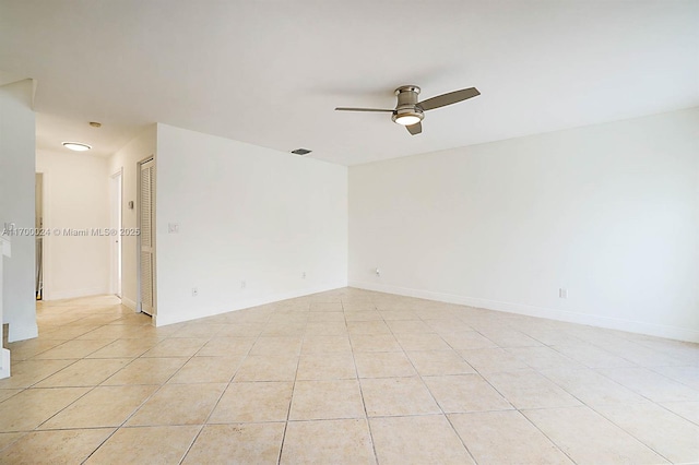 spare room featuring ceiling fan and light tile patterned flooring