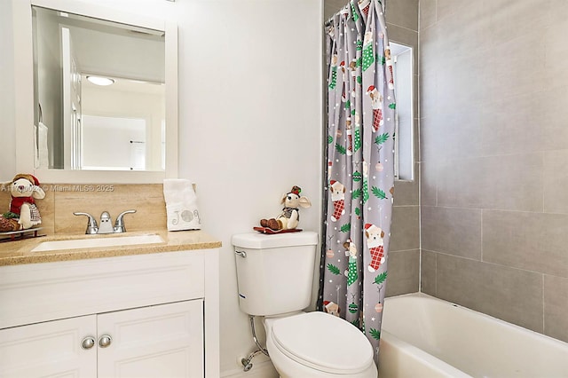 full bathroom featuring shower / bath combo, toilet, and vanity