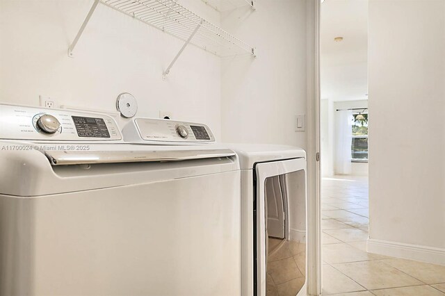 washroom with light tile patterned flooring and separate washer and dryer