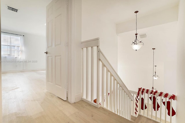 stairs with hardwood / wood-style flooring