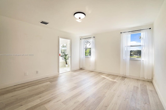 unfurnished room with light hardwood / wood-style floors and a healthy amount of sunlight