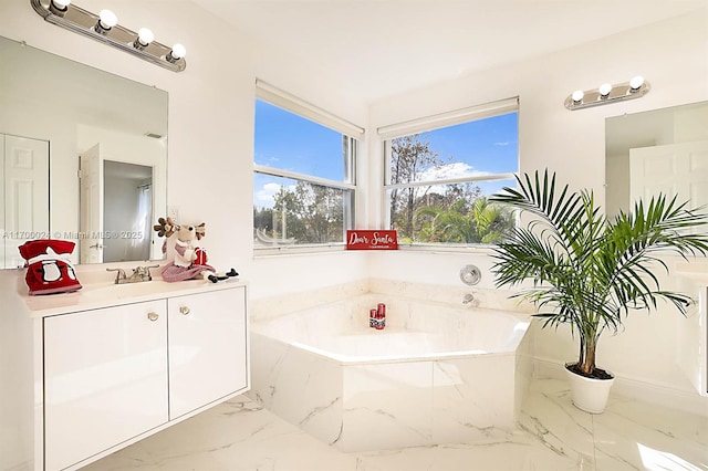 bathroom with vanity and a bath