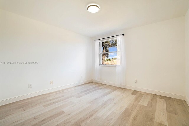 spare room featuring light hardwood / wood-style floors